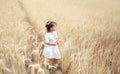 Little pensive girl in national Belarusian white clothes with a red ornament with a wreath of daisies on her head. Royalty Free Stock Photo