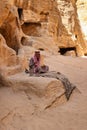 Unknown bedouin playing string instrument in little petra