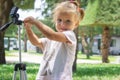 Little Photographer with Professional Tripod, girl playing outdoors Royalty Free Stock Photo