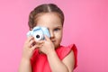 Little photographer taking picture with toy camera on background Royalty Free Stock Photo