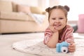 Little photographer with toy camera on floor at home Royalty Free Stock Photo