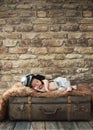 Little pilot baby sleeping on the luggage Royalty Free Stock Photo