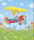 Little pilot in his plane over a town Royalty Free Stock Photo