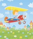 Little pilot in his plane over a town Royalty Free Stock Photo