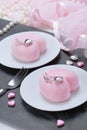 Little pink mousse cakes in the shape of a heart .