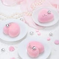 Little pink mousse cakes in the shape of a heart .