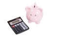 Little pink piggy bank with calculator on white Royalty Free Stock Photo