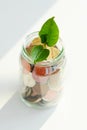 Little plant sprouting from pile of coins Royalty Free Stock Photo