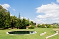 Little pond in the gardens of Quinta das Lagrimas and stone seats in Coimbra, Portugal