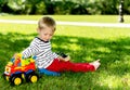 Little preschool boy playing with big toy car at city park Royalty Free Stock Photo