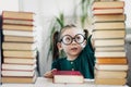 Little preschool cute girl genius reads a lot of of books. Kids education and early development concept Royalty Free Stock Photo