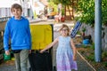 Little preschool girl with glasses and school kid boy taking garbage can. children learning waste sorting. Environment Royalty Free Stock Photo