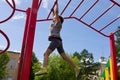 Little preschool girl hanging walk along the monkey bars Royalty Free Stock Photo