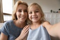 Little preschool girl making selfie with attractive young mother. Royalty Free Stock Photo