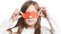 Little preschool girl and paper hearts. Isolated little girl covers her eyes with paper hearts on white background. close up