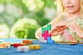 Little preschool girl playing board game with colorful bricks. Happy child build tower of wooden blocks, developing fine Royalty Free Stock Photo