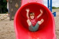 Little preschool girl playing on outdoor playground. Happy toddler child climbing and having fun with summer outdoors Royalty Free Stock Photo