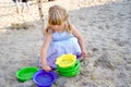 Little preschool girl playing with sand toys on the beach. Cute happy toddler child on family vacations on the sea Royalty Free Stock Photo