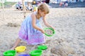 Little preschool girl playing with sand toys on the beach. Cute happy toddler child on family vacations on the sea Royalty Free Stock Photo