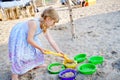 Little preschool girl playing with sand toys on the beach. Cute happy toddler child on family vacations on the sea Royalty Free Stock Photo