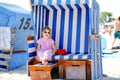 Little preschool girl resting on beach chair. Cute happy toddler child on family vacations on the sea. Kid playing Royalty Free Stock Photo