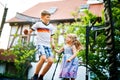 Little preschool girl and school kid boy jumping on trampoline. Happy funny siblings children having fun with outdoor Royalty Free Stock Photo