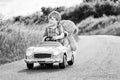 Little preschool kid boy driving big toy car and having fun with playing with his plush toy bear, outdoors. Child Royalty Free Stock Photo