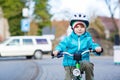 Little preschool kid boy riding with his first green bike Royalty Free Stock Photo