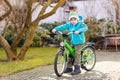 Little preschool kid boy riding with his first green bike Royalty Free Stock Photo