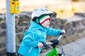 Little preschool kid boy riding with his first green bike Royalty Free Stock Photo