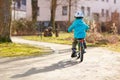 Little preschool kid boy riding with his first green bike Royalty Free Stock Photo