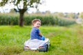 Little preschool kid girl sitting on old big toy car and having fun on sunny summer day Royalty Free Stock Photo