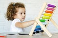 Little preschooler girl learning math. kid studying on mathematical abacus Royalty Free Stock Photo