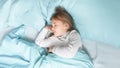 Little preschooler girl 4 years old sleeps in a bed in a blue linen. Sweet dream baby