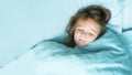 Little preschooler girl 4 years old sleeps in a bed in a blue linen. Sweet dream baby. space for text