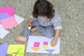 Little preschooler toddler girl gluing colorful paper. Royalty Free Stock Photo