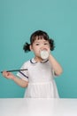 Little pretty Asian girl laughing portrait with milk and bread, healthy and happy lifestyle Royalty Free Stock Photo