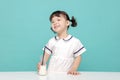 Little pretty Asian girl laughing portrait with milk and bread, healthy and happy lifestyle Royalty Free Stock Photo