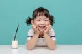 Little pretty Asian girl laughing portrait with milk and bread, healthy and happy lifestyle Royalty Free Stock Photo