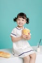 Little pretty Asian girl laughing portrait with milk and bread, healthy and happy lifestyle Royalty Free Stock Photo