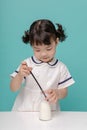 Little pretty Asian girl laughing portrait with milk and bread, healthy and happy lifestyle Royalty Free Stock Photo