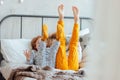 Little pretty brother and sister in pajamas lying in bed, cozy morning, focus on legs Royalty Free Stock Photo