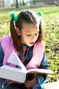 Little pretty child reading the book