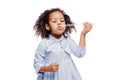 Little pretty fashionable african american girl in blue dress blowing soap bubbles on white background Royalty Free Stock Photo
