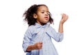 Little pretty fashionable african american girl in blue dress blowing soap bubbles on white background Royalty Free Stock Photo