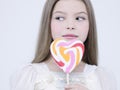 Little pretty girl with big candy Royalty Free Stock Photo