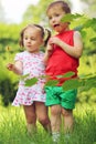 Little pretty girl and boy lick lollipops in Royalty Free Stock Photo