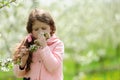 Little pretty girl dreaming in the green garden Royalty Free Stock Photo