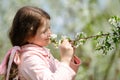 Little pretty girl dreaming in the green garden Royalty Free Stock Photo