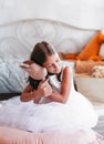 Little pretty girl hugs her soft toy. A child sits on the floor in a light room Royalty Free Stock Photo